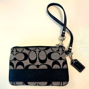 Coach signature canvas wristlet with leather strap.